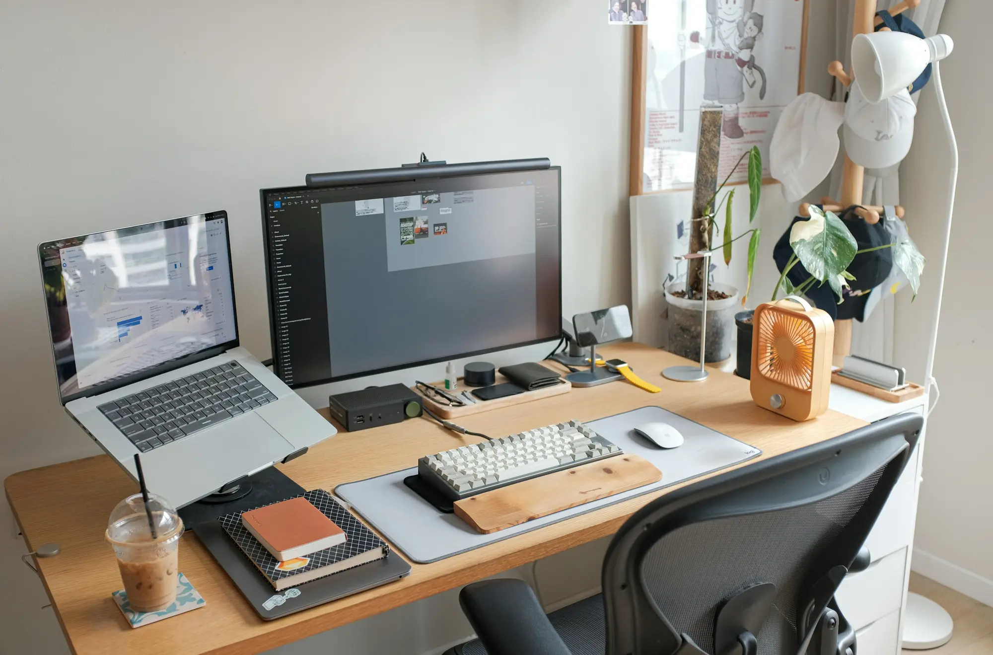 Laptop and external monitor on a clean wooden desk — a dual-screen travel work setup