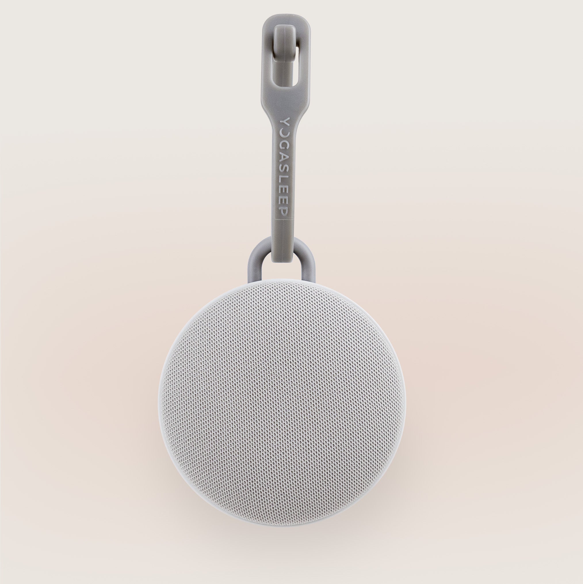 Yogasleep Hushh 2 portable sound machine on beige background
