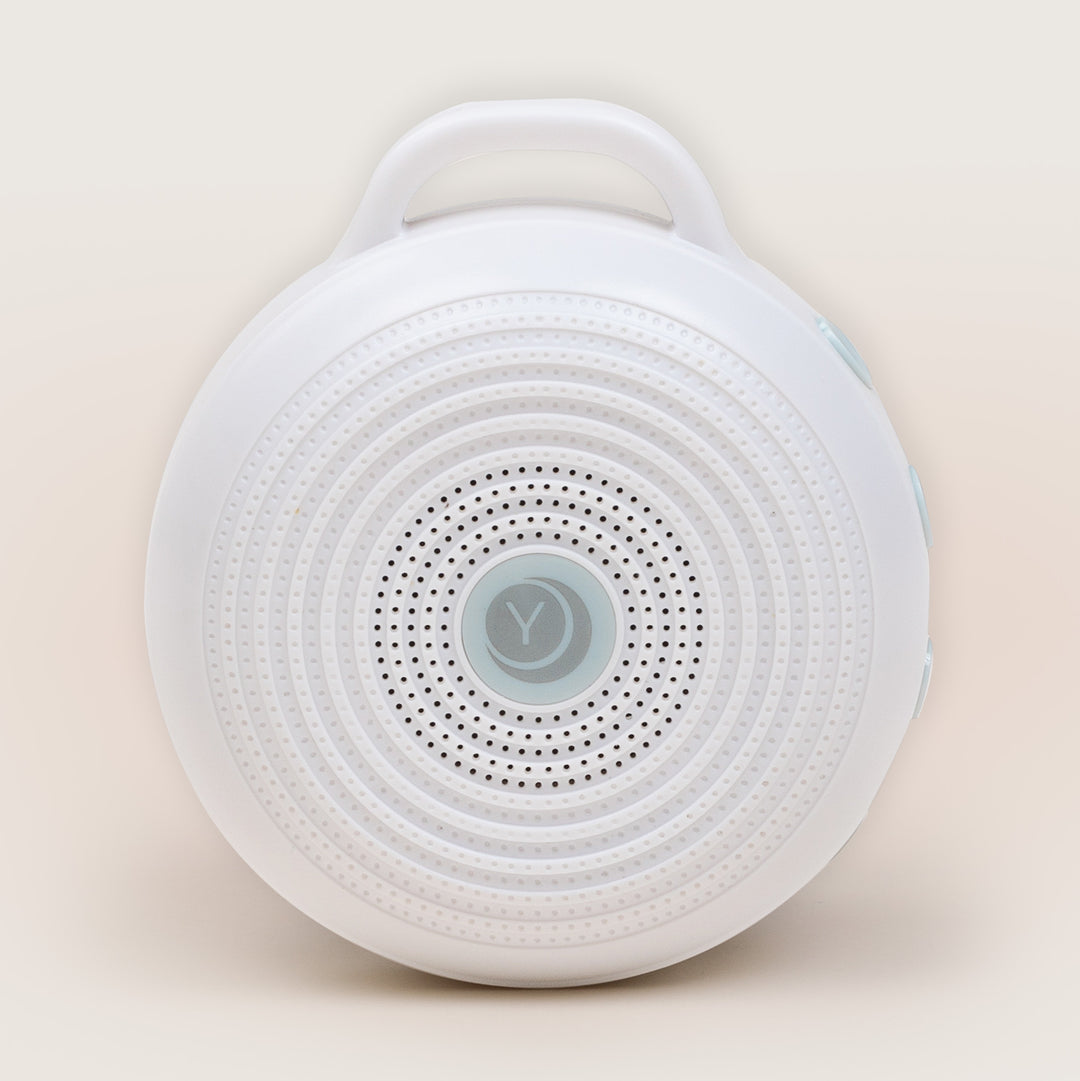 Yogasleep Rohm portable white noise machine on beige background